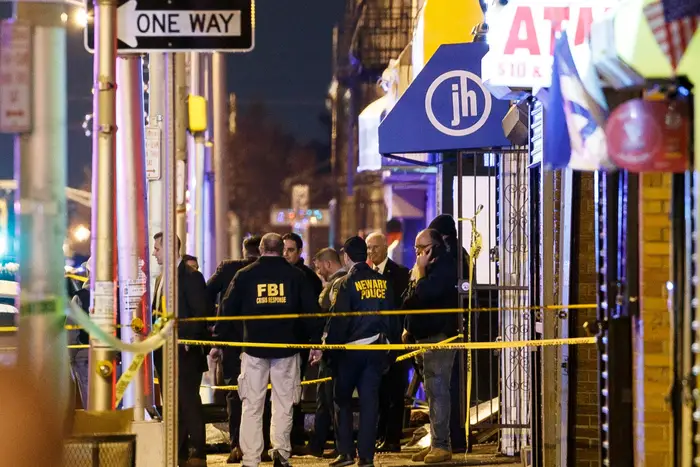 Police secure and investigate the scene of a multiple shooting in Jersey City, New Jersey, on December 10, 2019.